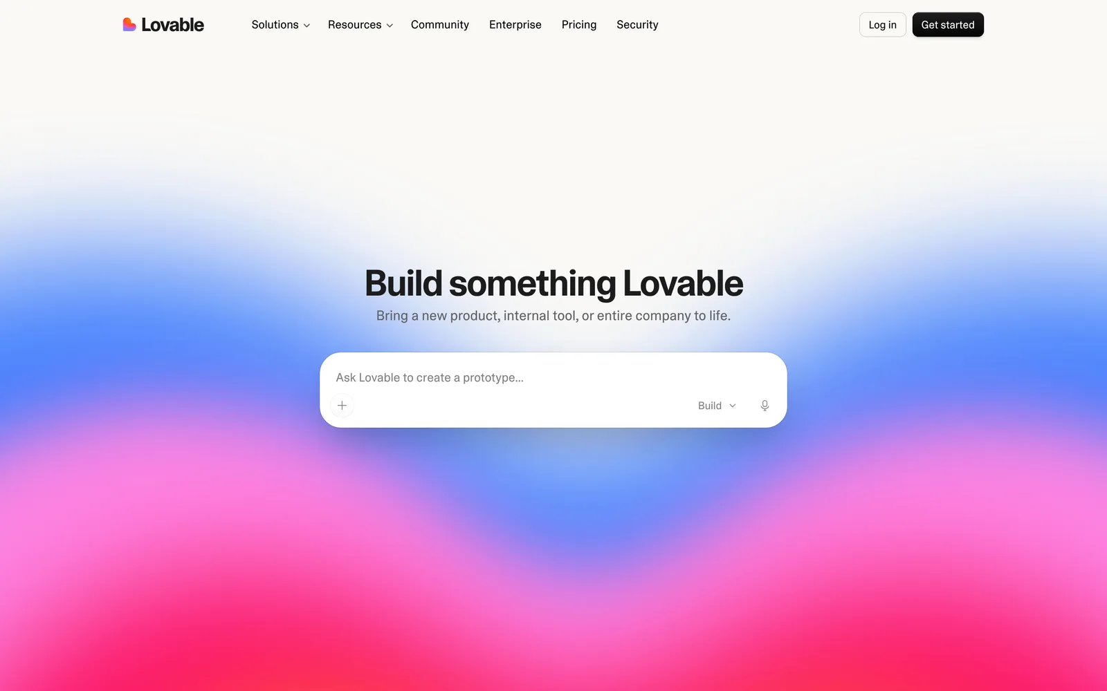 Lovable homepage with the headline Build something Lovable and a prompt box reading Ask Lovable to create a prototype, with an attach button and a Build mode selector
